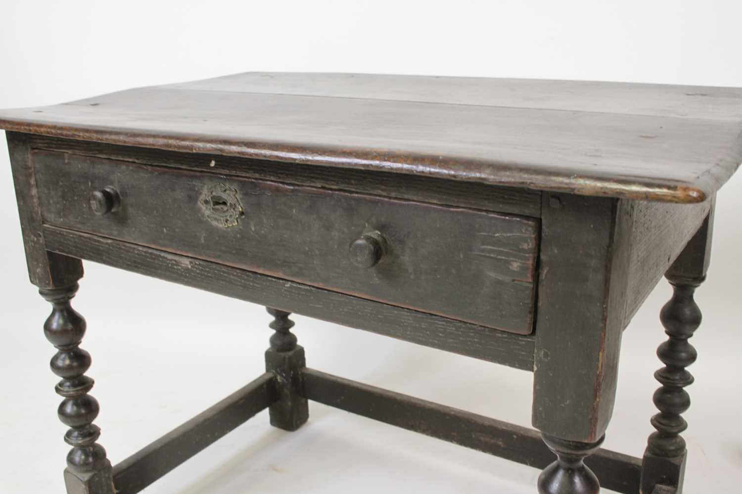 A circa 1700 joined oak single drawer side table, having a two-plank top and raised on bobbin turned - Image 3 of 4