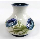 An early 20th century Moorcroft MacIntyre miniature squat vase in the Poppy Garland pattern, of