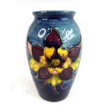 A small mid-20th century Moorcroft pottery vase in the Clematis pattern, of ovoid form, underglaze