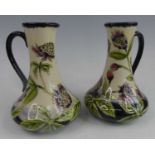 A pair of Cobridge Stoneware ewers in the Astrantia pattern, each of lower bulbous form, designed by