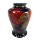 An early 20th century Moorcroft miniature pottery vase in the Pomegranate pattern, of shouldered