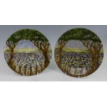 A pair of Cobridge Stoneware plates in the Caley Hill pattern, underglaze painted, impressed and