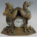 A Cobridge Stoneware novelty mantel clock, decorated with grotesque birds, designed by Andrew