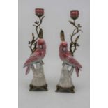 A pair of modern continental table candlesticks, each in the form of a parrot issuing a gilt metal