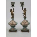 A pair of modern table candlesticks, each in the form of a gilt metal cherub sporting a single