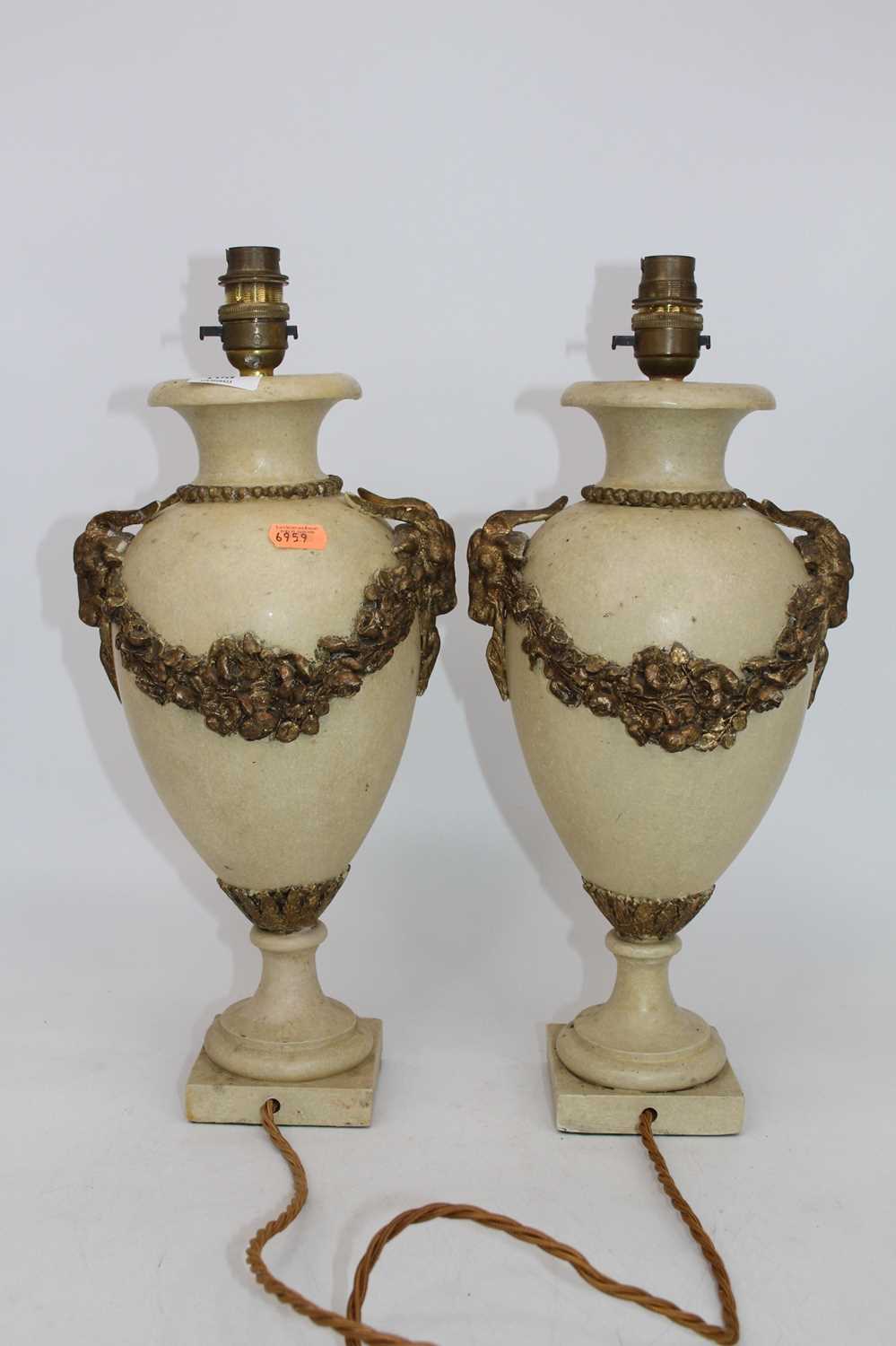 A pair of marble table lamps, each of baluster form having gilt metal mounts with ram's mask and