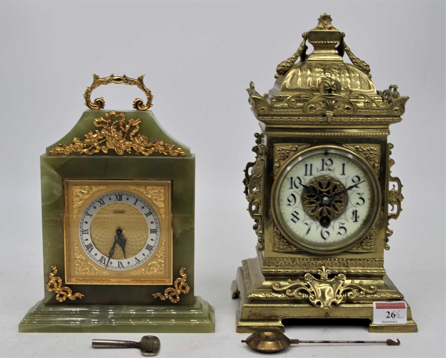 A 19th century brass cased mantel clock having a caddy type top with shell finial, above an