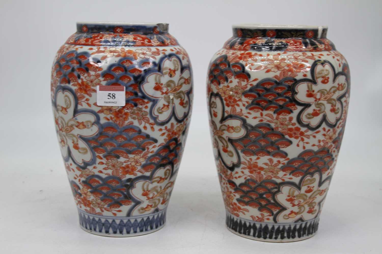 A pair of Japanese late Meiji vases, of baluster form, decorated in the imari palette in shades of