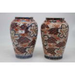 A pair of Japanese late Meiji vases, of baluster form, decorated in the imari palette in shades of