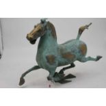 A Chinese bronze alloy and verdigris model of a prancing horse, height 31cm