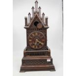 A late 19th century Continental oak cased cuckoo clock of Gothic architectural form having applied