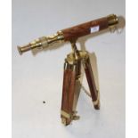 A reproduction lacquered brass and teak telescope on tripod base