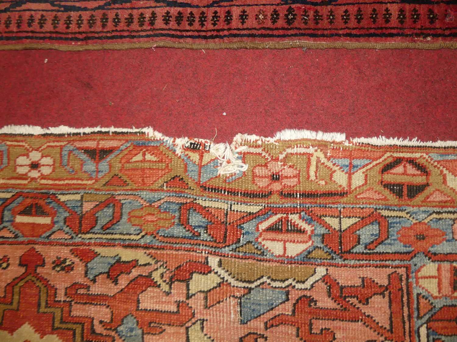 A Persian woollen Heriz red ground rug, the quatraform medallion within stepped spandrels, 190 x - Image 7 of 9