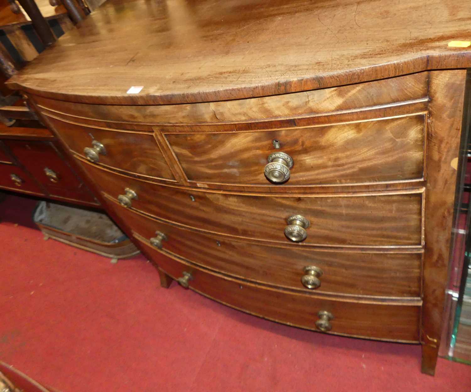 A George IV mahogany bowfront chest of two short over three long drawers, on outswept supports,