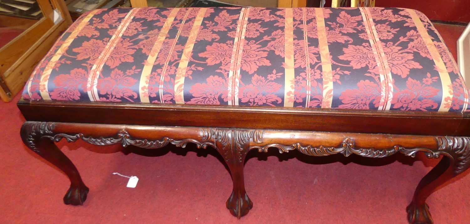 A contemporary mahogany striped floral silk damask topped twin dressing stool, raised on acanthus