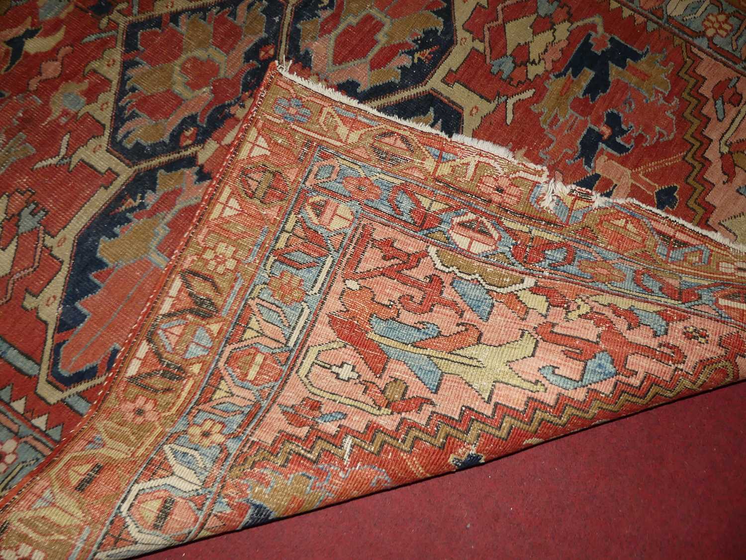 A Persian woollen Heriz red ground rug, the quatraform medallion within stepped spandrels, 190 x - Image 8 of 9