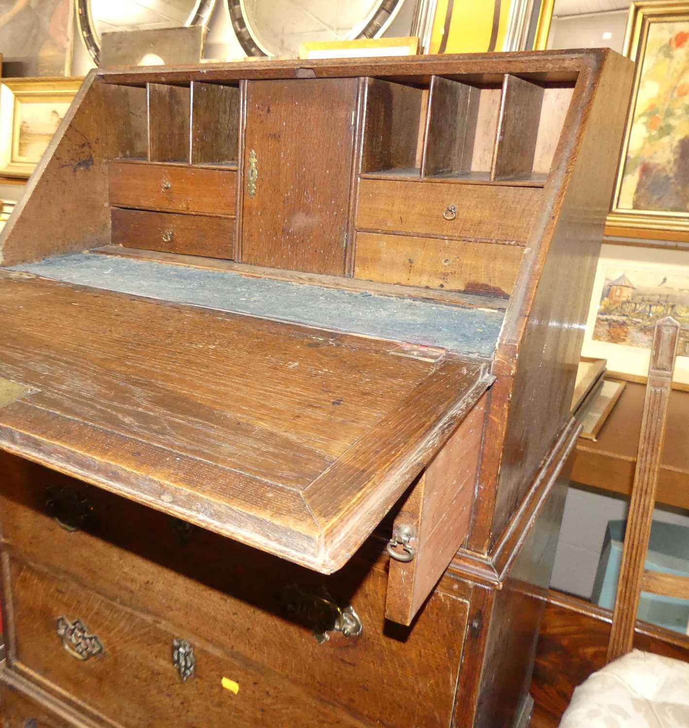 An early 19th century provincial oak slope front three-drawer writing bureau, width 72cm