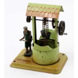 A Fleischmann early 20th century tinplate model of a model well, steam engine powered example,