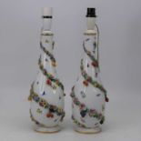 A pair of early 20th century Dresden porcelain vases, each of teardrop shape with applied floral