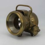 An early 20th century brass cased car lamp, bearing a plaque for Mangin lens mirror, patent number