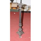 A cast iron ecclesiastical style pricket candlestick, having a single sconce on a fluted column