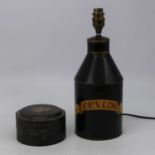 A toleware tin converted to a table lamp, black painted with Ceylon within scroll, height 32cm (