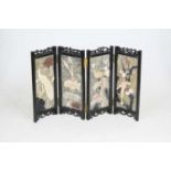 A reproduction Chinese polished hardstone table screen, relief decorated with birds amongst flowers,