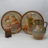 A pair of 20th century studio pottery chargers, incised with a fisherman and fisherwoman,