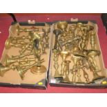A large collection of 18th century and later brass candlesticks, some in pairs and some single