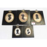 A collection of five Victorian portrait silhouettes, each housed within an ebonised frame, the