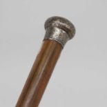 A late Victorian walking cane having a malacca shaft and silver pommel with all over floral engraved