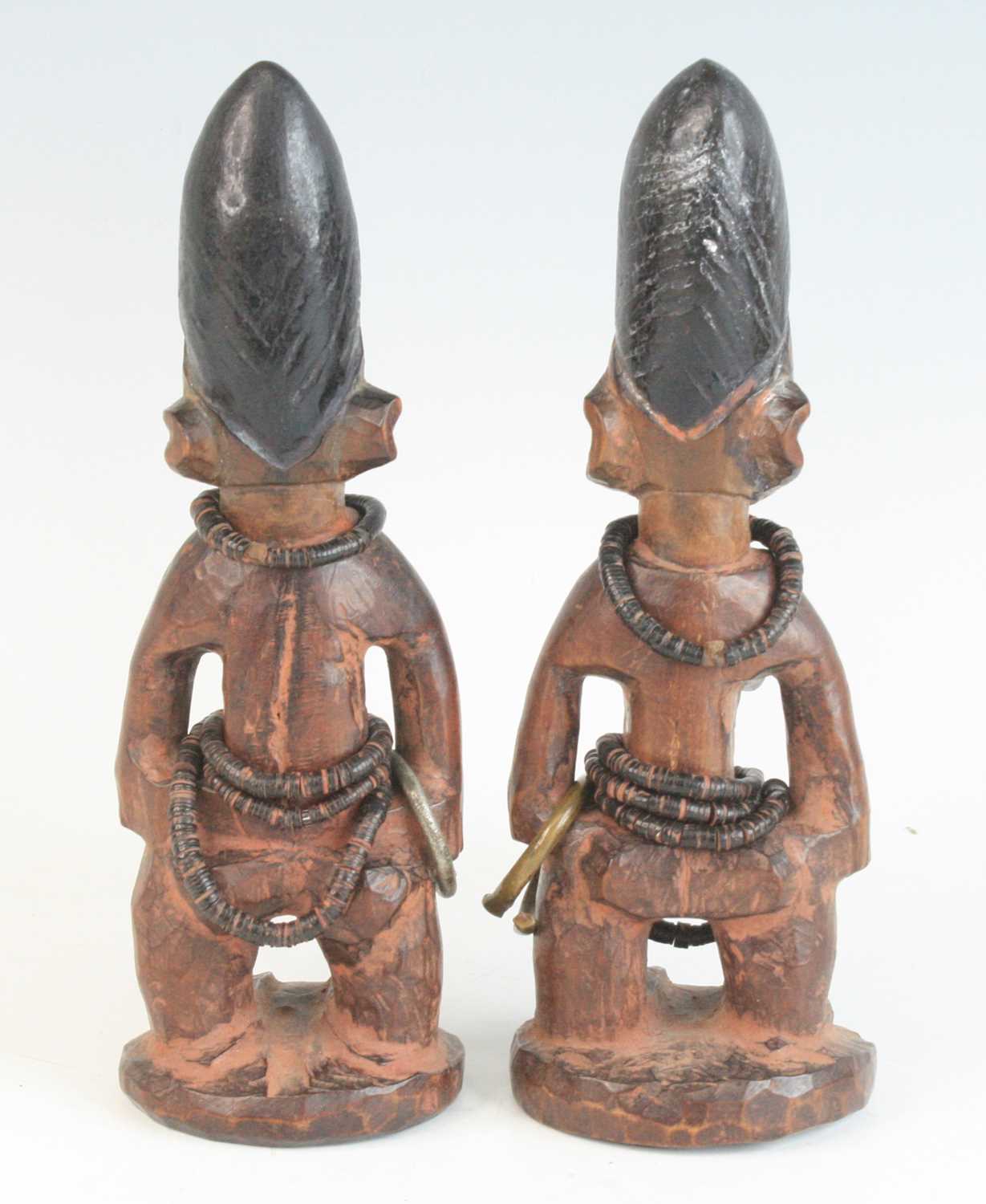 A pair of Ibeji figures, each carved as a female in standing pose with scarified cheeks and - Image 4 of 5