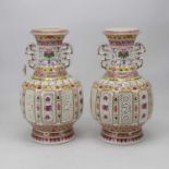 A pair of reproduction Chinese export vases, each of baluster form having reticulated body in the