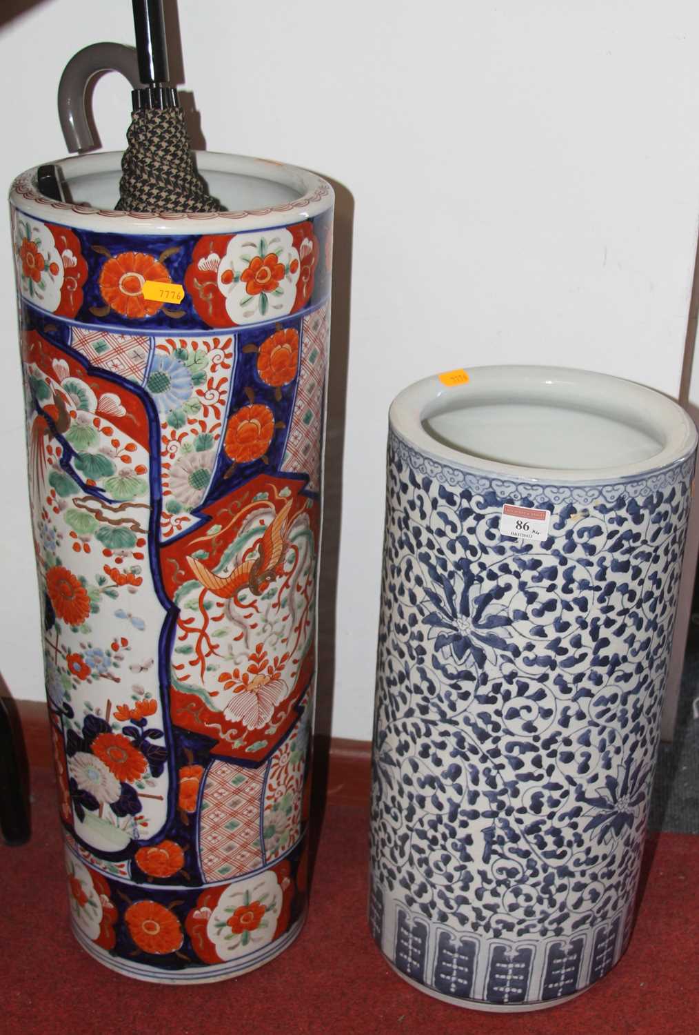A ceramic stickstand, of typical form, decorated in the imari palette, containing various umbrellas;