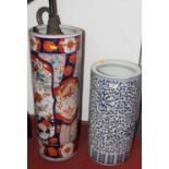 A ceramic stickstand, of typical form, decorated in the imari palette, containing various umbrellas;