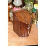 A George III mahogany and boxwood strung knife box, of serpentine outline, the hinged lid opening to