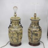 A pair of contemporary table lamps of baluster form, underglaze decorated in the Chinese style on