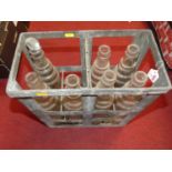 A collection of seven moulded glass motor oil bottles, to include ESSO Lube in galvanised crate