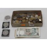 A collection of coins banknotes, and tokens to include a 1951 crown, threepenny pieces, with foreign