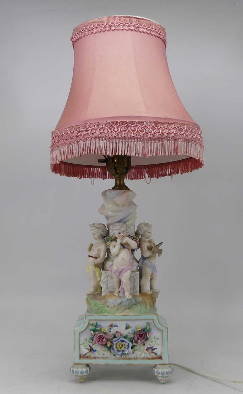 An early 20th century Dresden porcelain table lamp, the single gilt metal sconce on a fluted