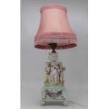 An early 20th century Dresden porcelain table lamp, the single gilt metal sconce on a fluted