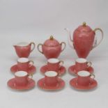 A Wedgwood bone china six place setting coffee service of pink ground heightened in gilt
