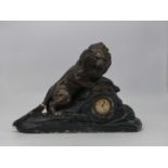 A French Art Deco painted plaster mantel clock, modelled in the form of a lion on rocky outcrop,