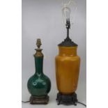 A 20th century ceramic table lamp on a mustard ground with metal fittings, height 70cm including