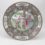 A large oriental charger, the central enamel decorated with various figures within a famille verte