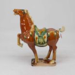 A Chinese sancai glazed model of a tang horse, height 34cm, together with a ceramic plaque decorated