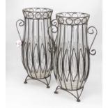 A pair of large glass vases, of fluted form within cast iron mount, with twin scrolling handles, h.