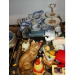 Two boxes of miscellaneous items, to include a large pottery model of a seated cat, novelty teapots,