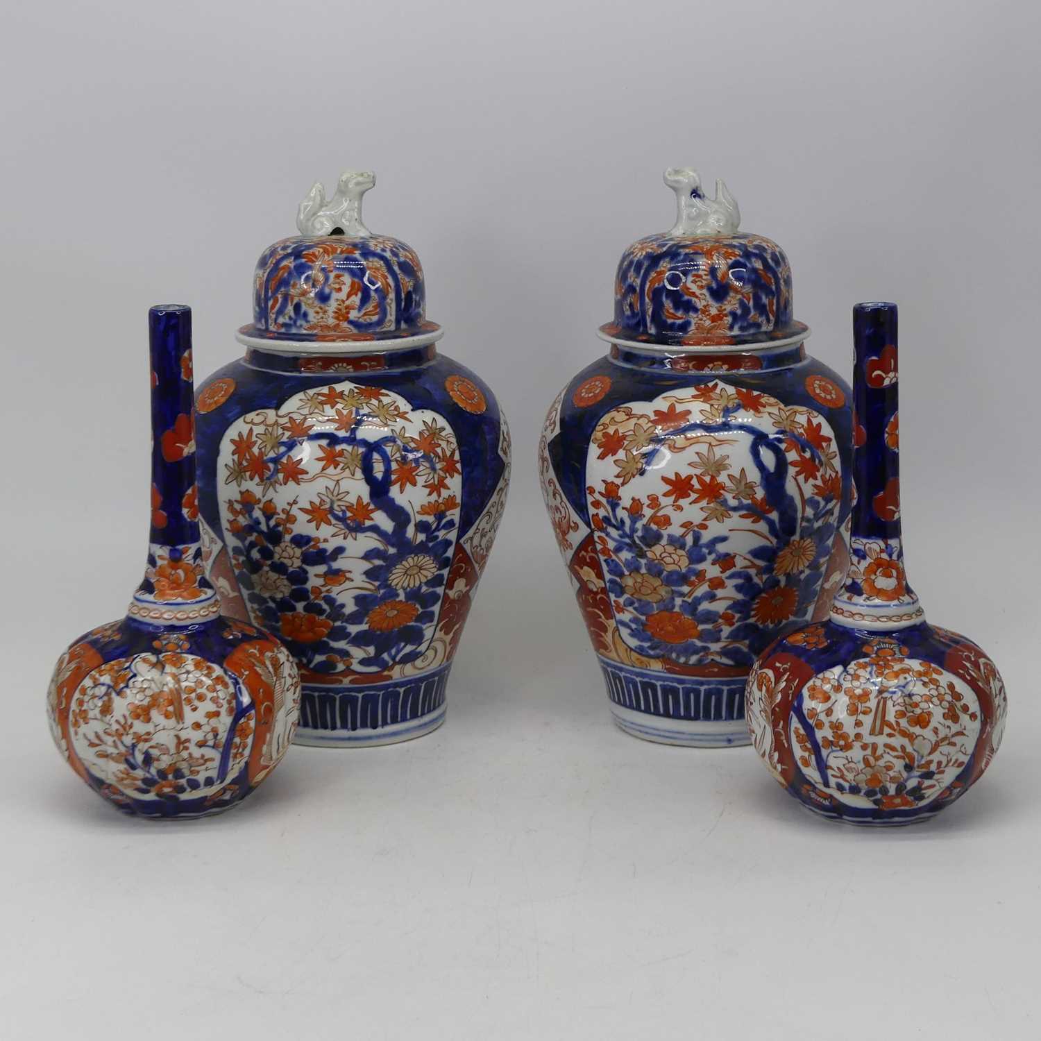 A pair of Japanese Imari bottle vases, each having a slender tapering neck to a compressed melon