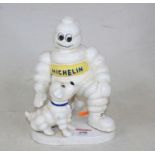 A reproduction cast iron model of the Michelin Man and his dog, h.20cm